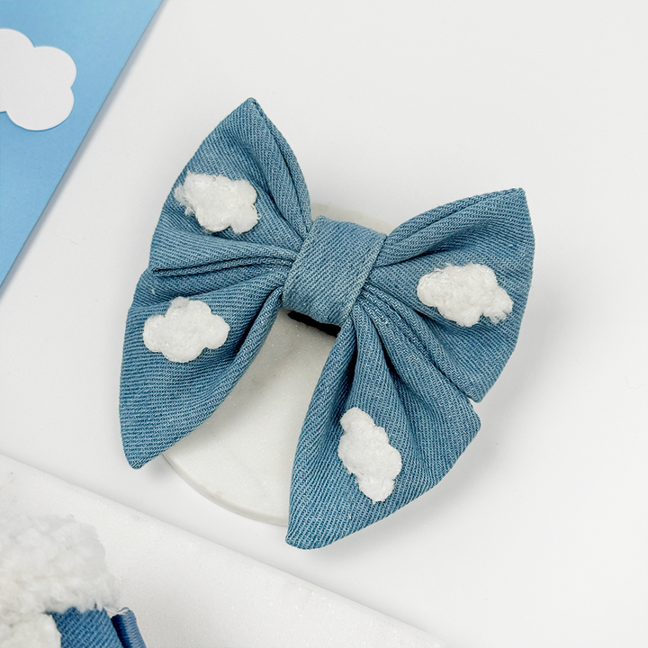 Denim blue Dog Bow Tie with cloud decorations on a white background