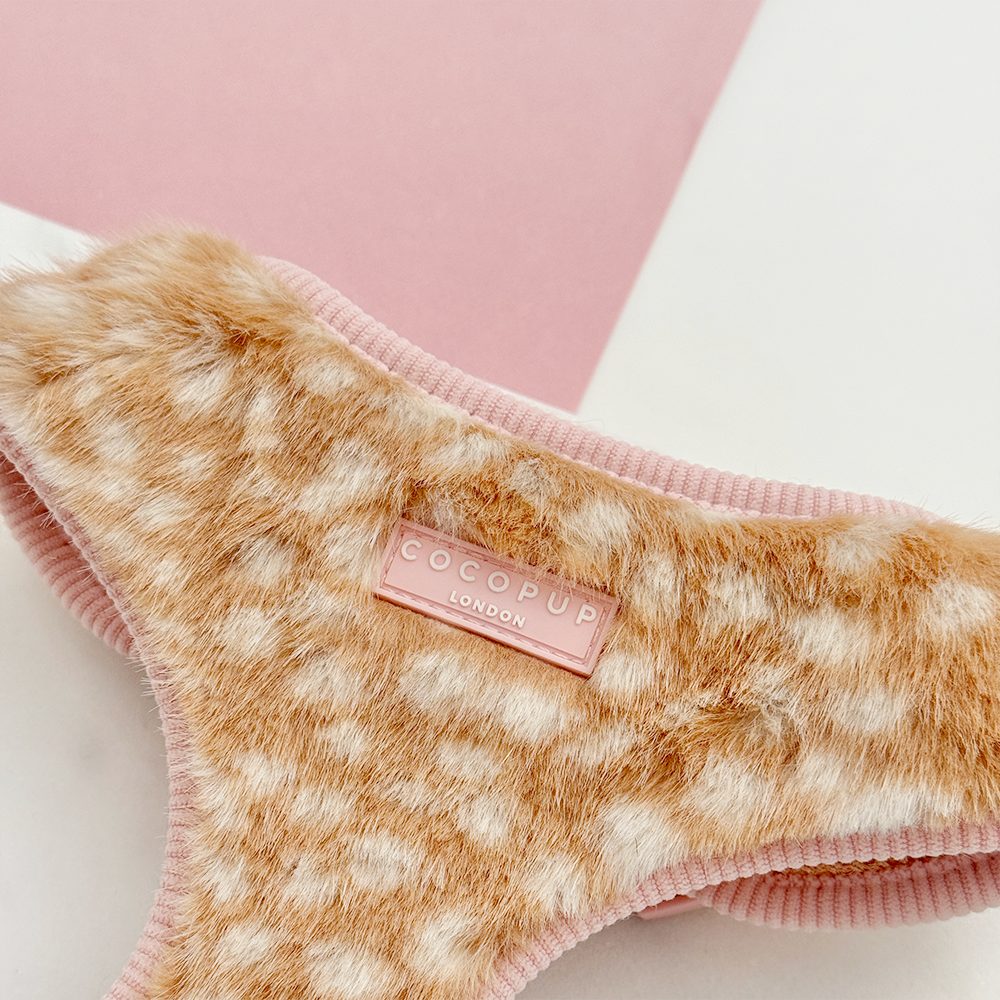 Faux fur dog harness in a beige and cream fawn pattern with pink ribbed trim.