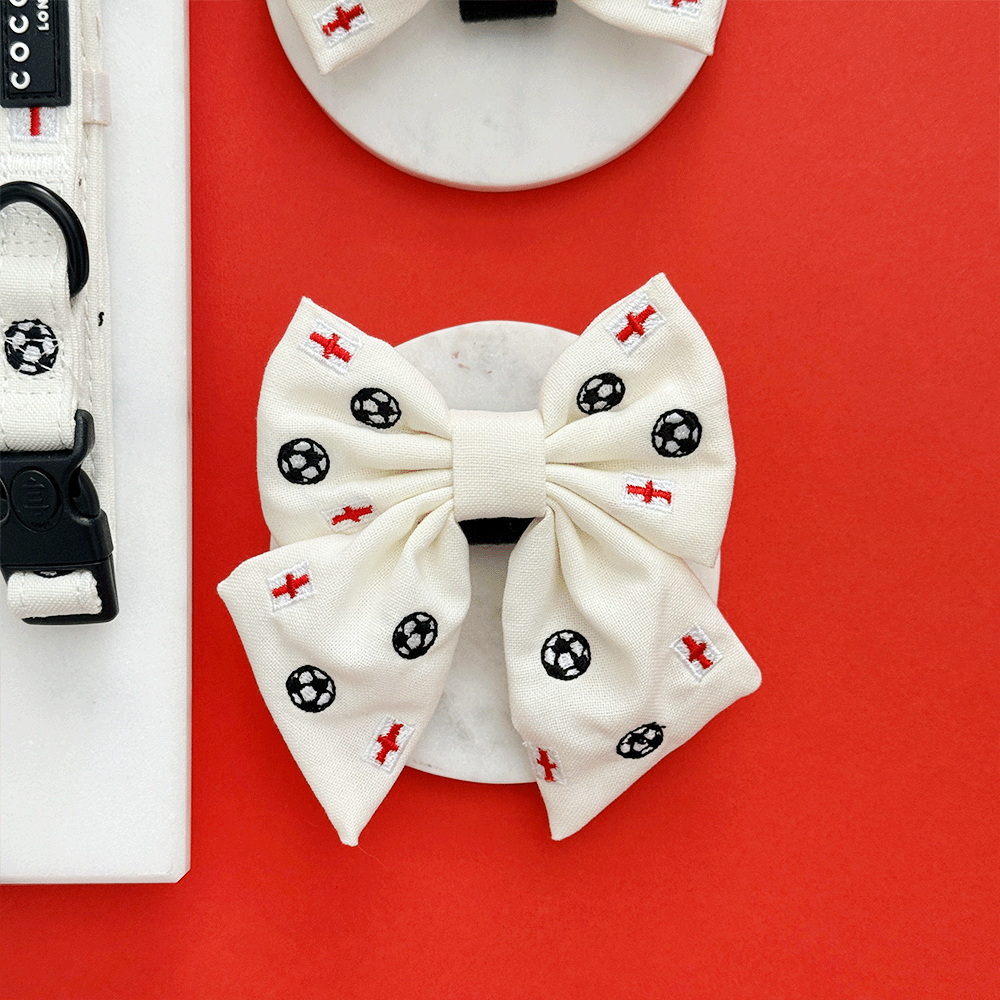White Dog Sailor Bow Tie with embroidered footballs and England flags.