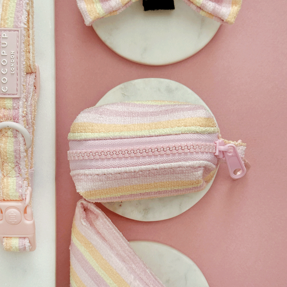 Pink, yellow and orange striped Dog Poop Bag Dispenser with pink Cocopup logo badge. With zip closure to hold two rolls of poo bags.
