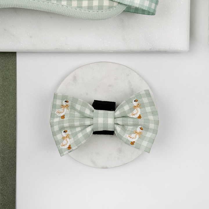 Green and white check print dog bow tie with embroidered geese design.