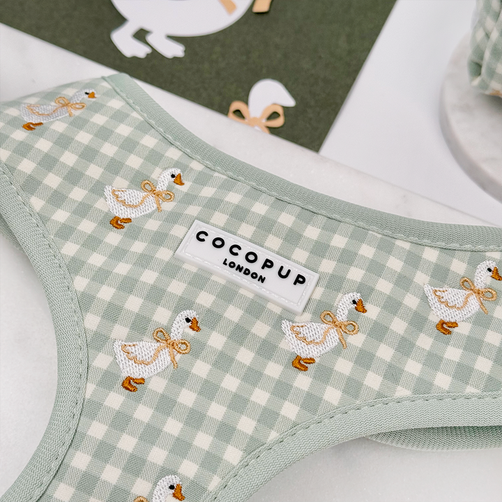 Green and white check print dog harness with embroidered geese design.