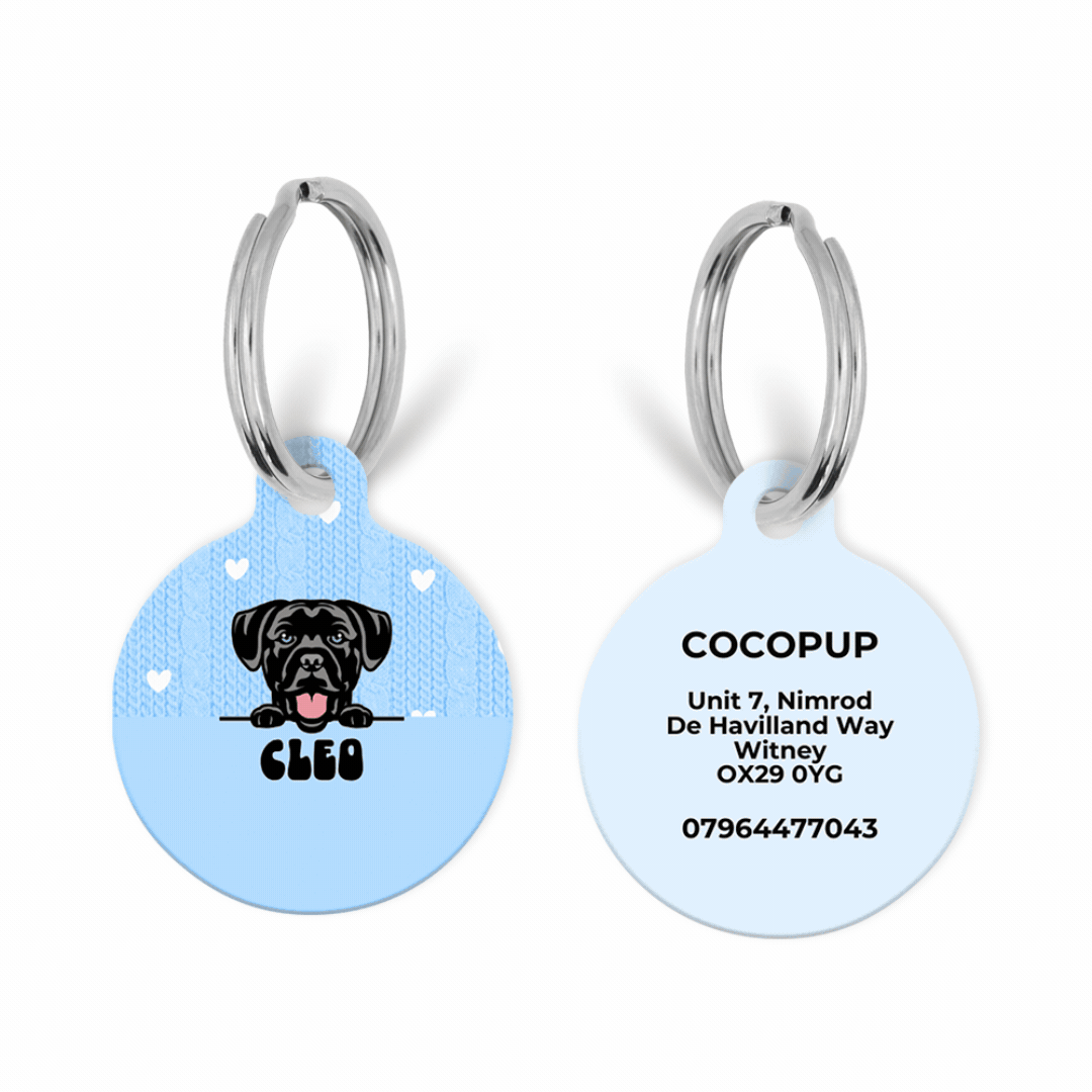 Two round blue Cocopup ID tags with a cartoon black dog, CLEO name, and contact details in black text.